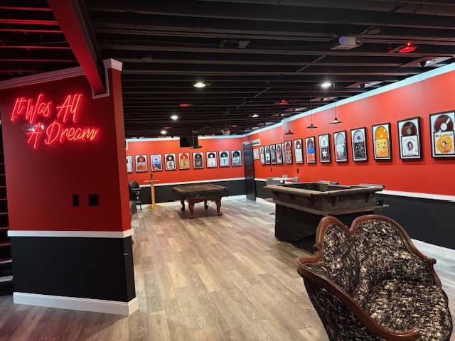 The L7067 great room revealing rows of framed music artifacts