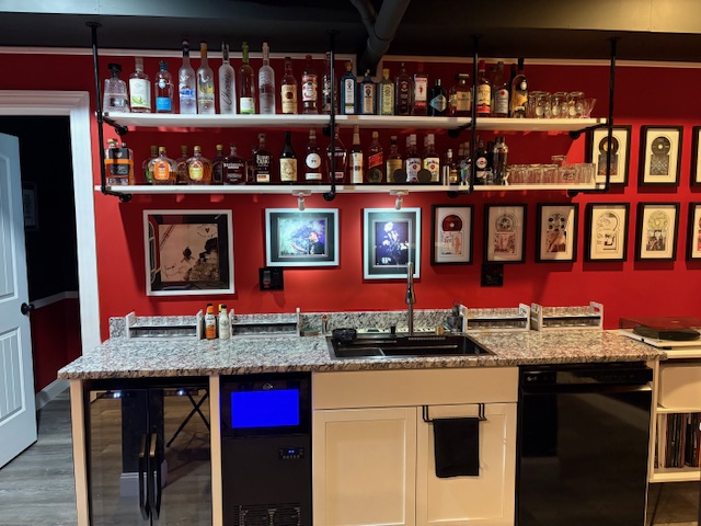 Wide view of the L7067 Bar with liquor wall and framed artifacts