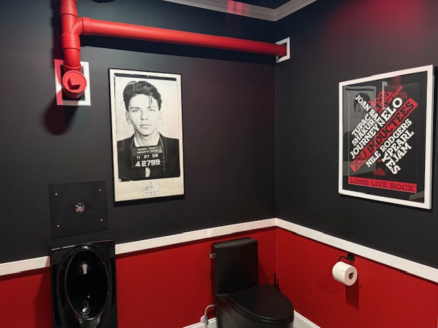 The Rock & Roll Restroom at The Ryan Lewis Collection — Frank Sinatra mugshot and Rock Hall poster